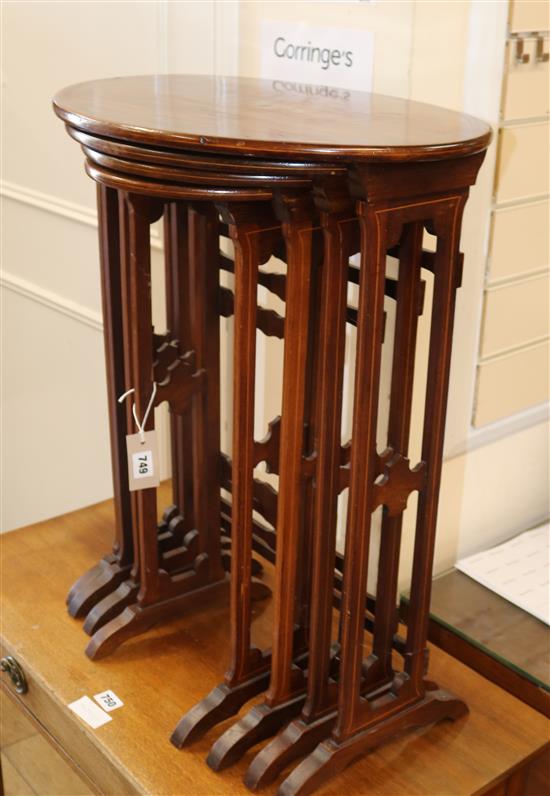 A nest of four Edwardian inlaid mahogany oval tables W.52cm